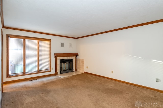 unfurnished living room with light carpet, a fireplace, and crown molding