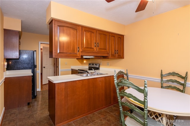 kitchen featuring ceiling fan, sink, kitchen peninsula, a textured ceiling, and stainless steel electric stove