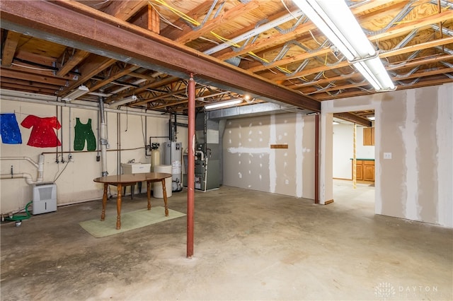 basement featuring water heater and heating unit