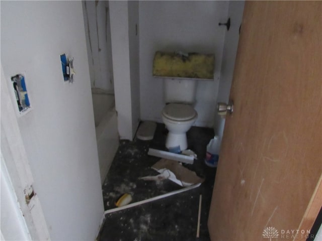 bathroom featuring toilet and a bath