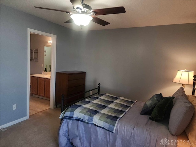 carpeted bedroom with connected bathroom and ceiling fan