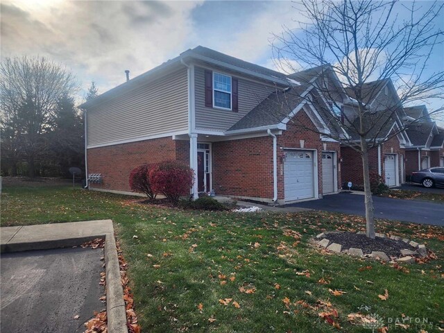 view of side of property with a lawn and a garage