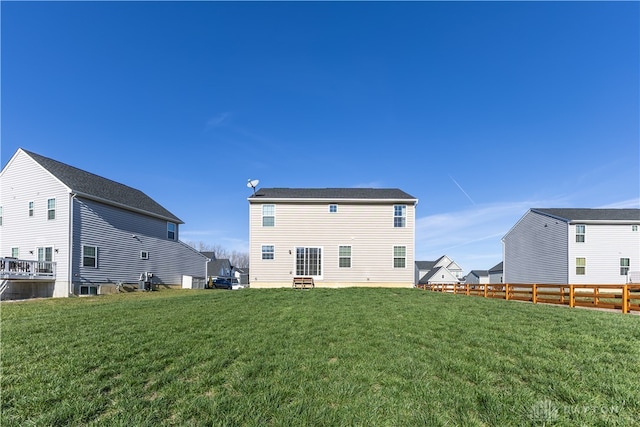 rear view of house with a yard