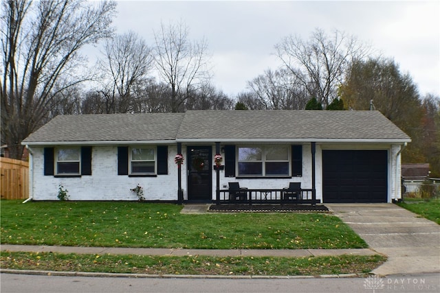 ranch-style home featuring a front lawn, a porch, and a garage