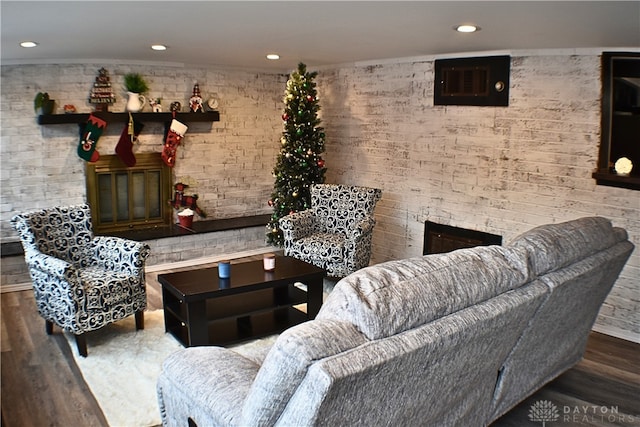 living room with hardwood / wood-style flooring and a fireplace