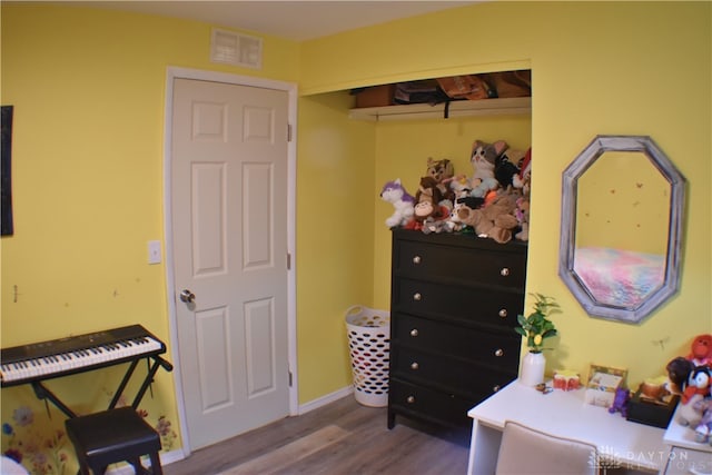 bedroom featuring hardwood / wood-style flooring and a closet