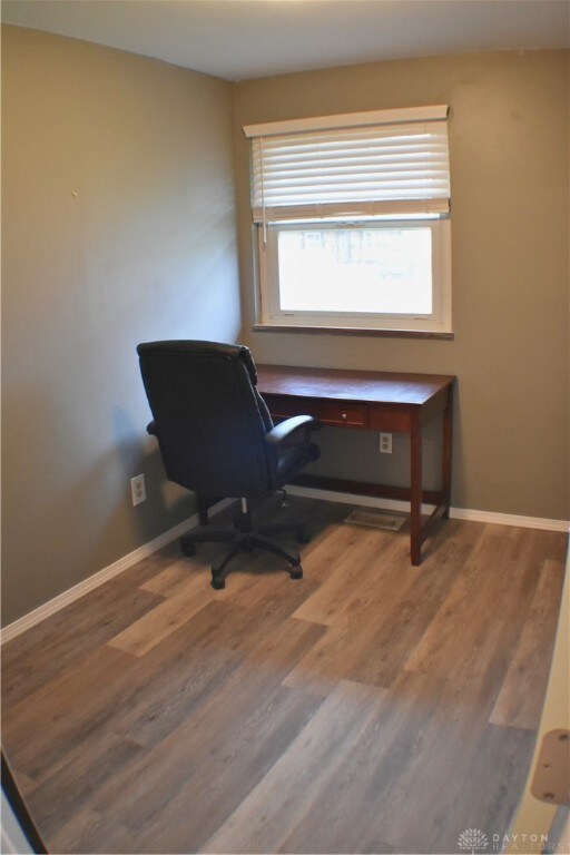 home office with hardwood / wood-style flooring