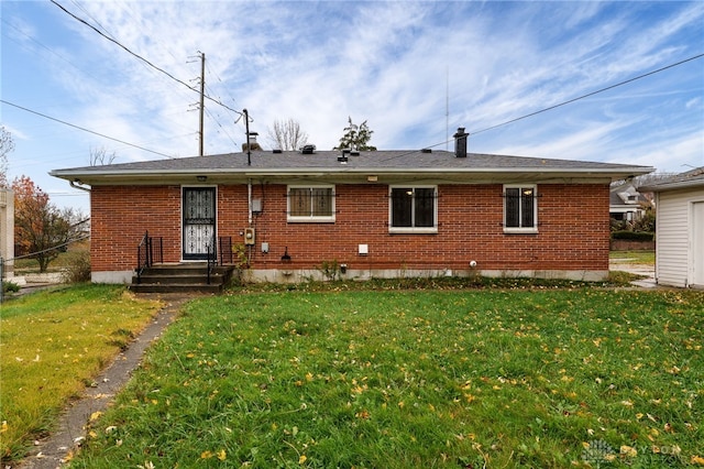 back of house featuring a yard