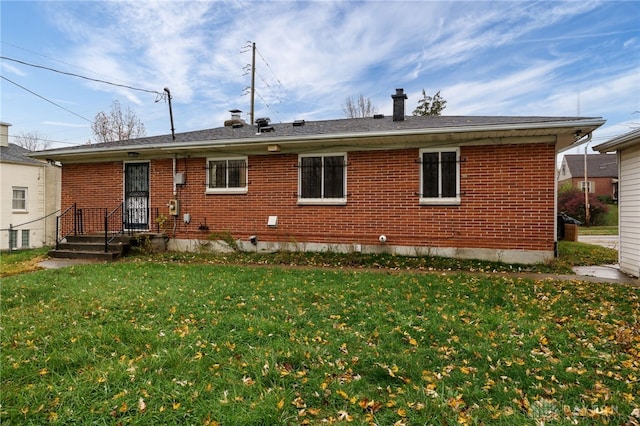 rear view of house with a yard