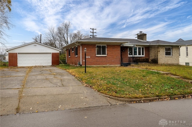 view of front of home featuring an outbuilding, a front lawn, and a garage