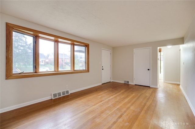 spare room featuring light hardwood / wood-style flooring