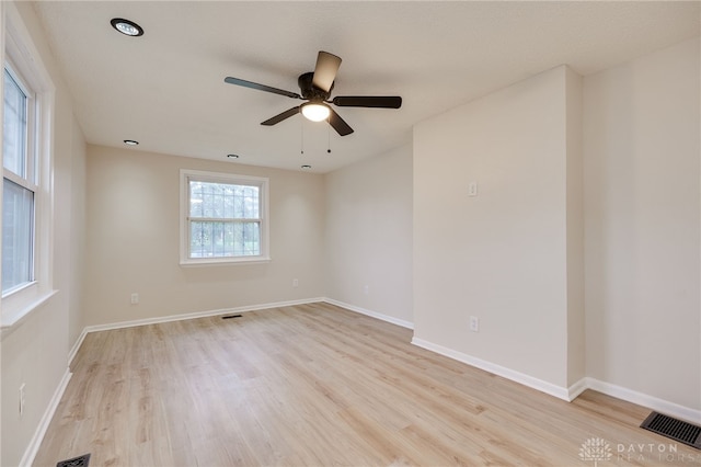 unfurnished room with ceiling fan and light wood-type flooring