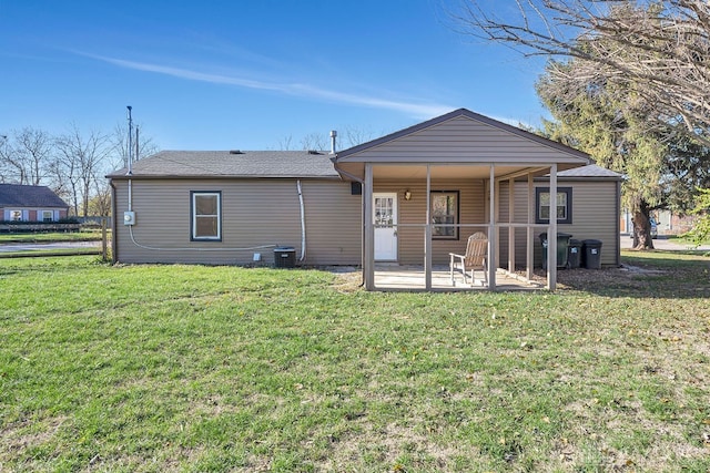 back of property featuring cooling unit, a yard, and a patio