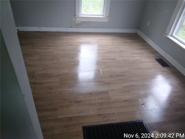 unfurnished room with wood-type flooring