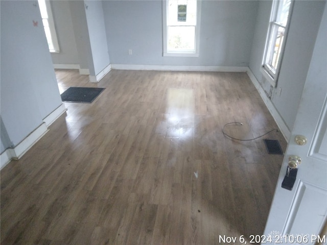 unfurnished room with dark wood-type flooring