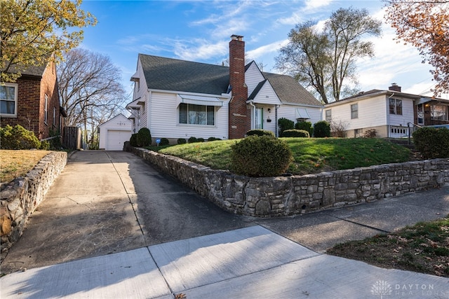 view of front of house with an outbuilding, a front yard, and a garage