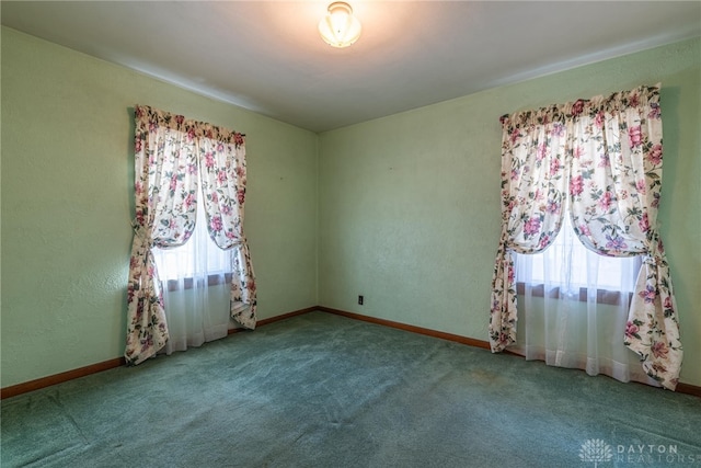 empty room featuring carpet flooring and a healthy amount of sunlight