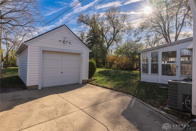 garage with a lawn and central AC