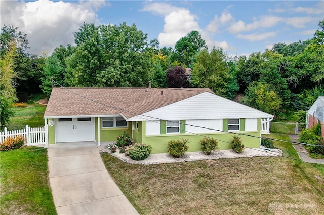 ranch-style home with a garage and a front lawn