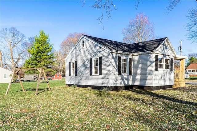 view of side of home with a lawn