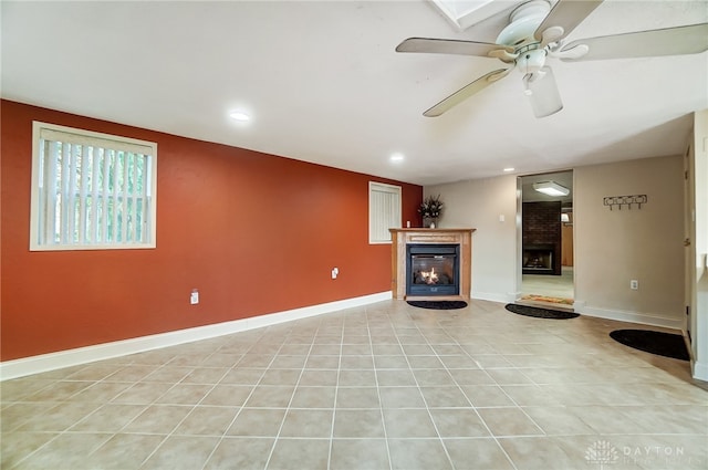 unfurnished living room featuring ceiling fan and light tile patterned floors