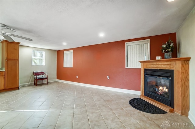 interior space with ceiling fan and light tile patterned flooring