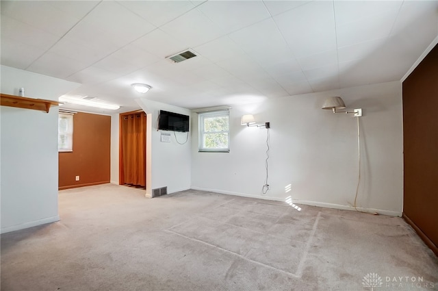 basement featuring light colored carpet