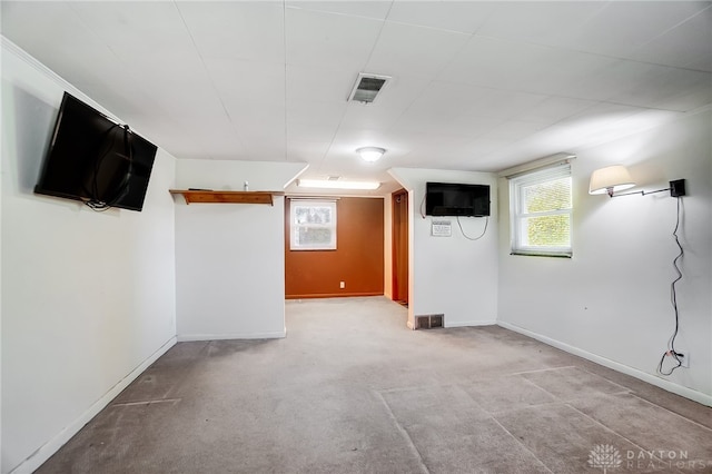 basement featuring light colored carpet