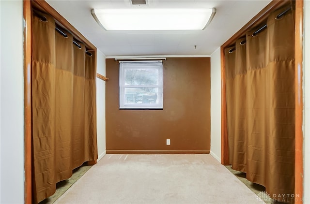 unfurnished bedroom with light carpet and ornamental molding