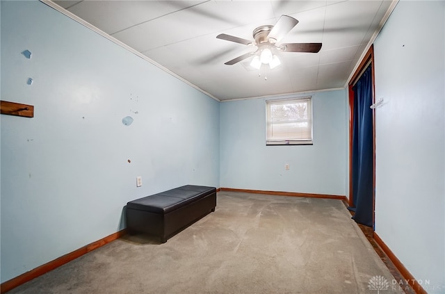 unfurnished room featuring ceiling fan, crown molding, and light carpet