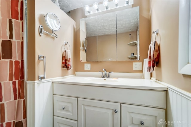 bathroom with vanity and a textured ceiling