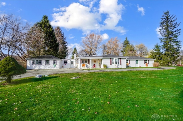 view of front of property with covered porch and a front yard