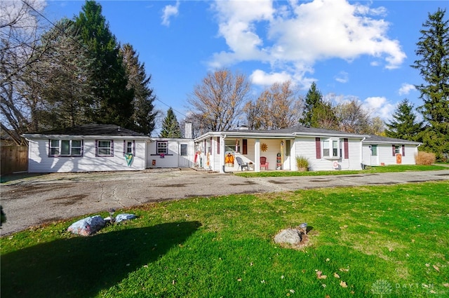 single story home with a porch and a front lawn