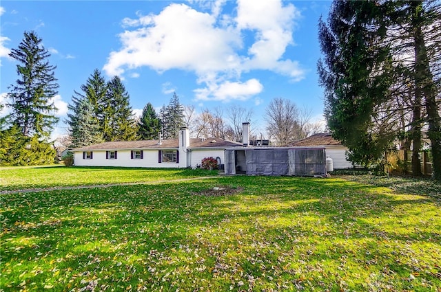 rear view of house with a lawn