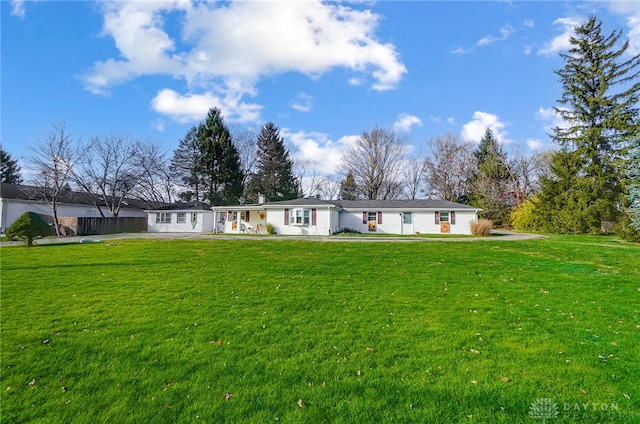 rear view of house featuring a yard