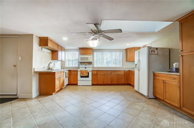 kitchen with light tile patterned floors, white appliances, ceiling fan, and sink