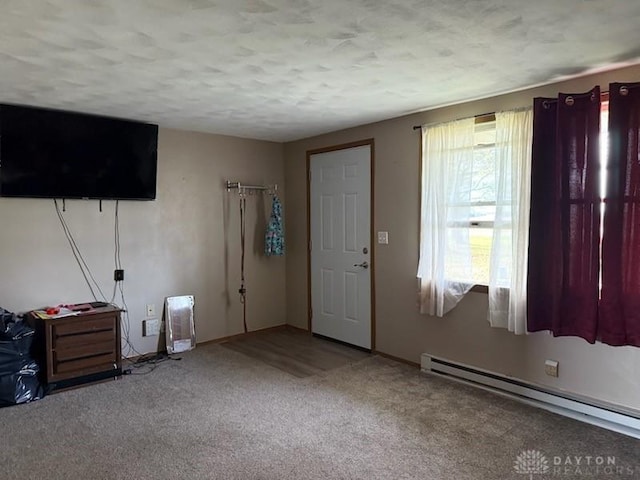 interior space featuring carpet floors and baseboard heating