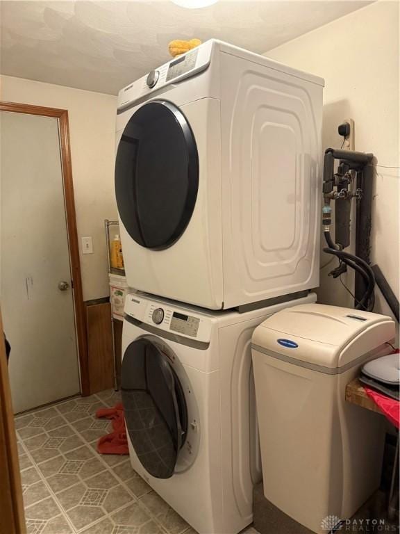 laundry area featuring stacked washer and dryer