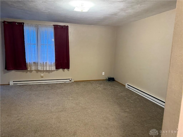 unfurnished room with carpet flooring, a textured ceiling, and a baseboard heating unit