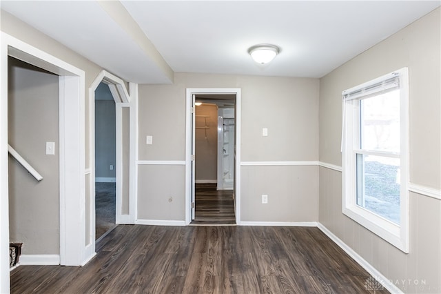 unfurnished room with dark hardwood / wood-style floors and a wealth of natural light