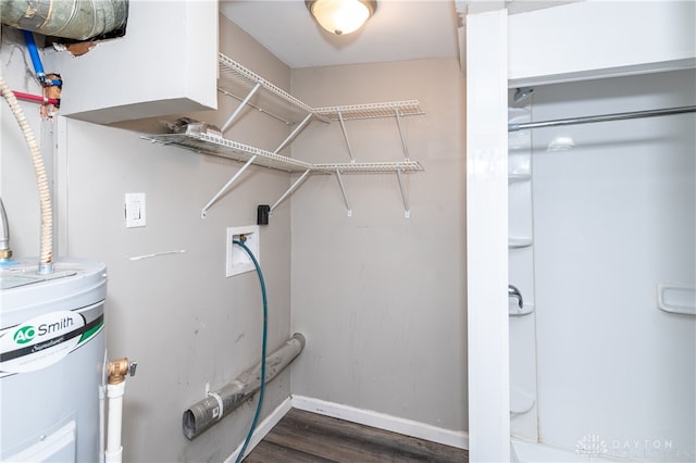 laundry room with electric water heater, washer hookup, and dark hardwood / wood-style floors