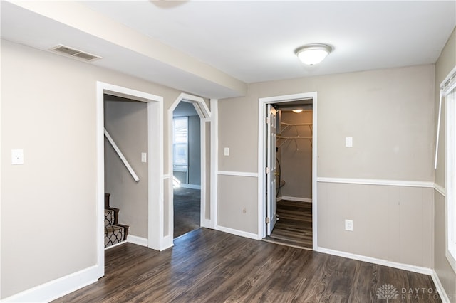 unfurnished room with dark hardwood / wood-style flooring