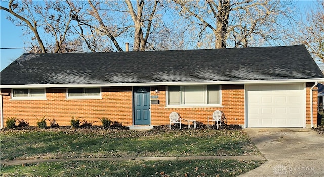 ranch-style house featuring a garage and a front lawn