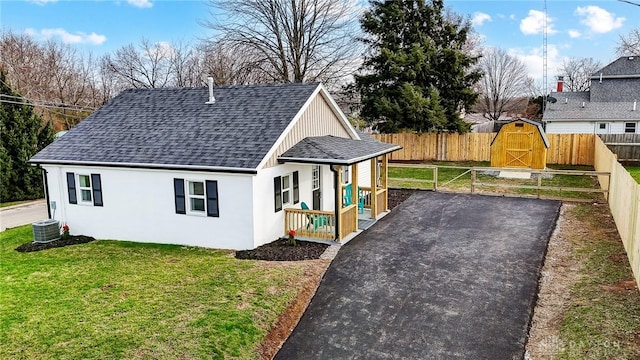 exterior space featuring a front lawn and cooling unit