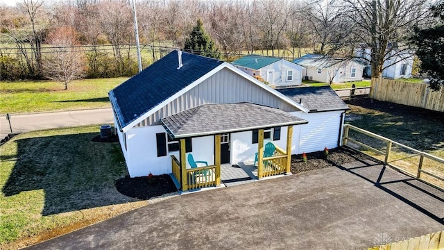 view of front of property with covered porch and a front yard