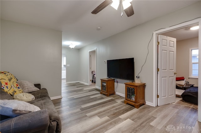 living room featuring ceiling fan and light hardwood / wood-style floors