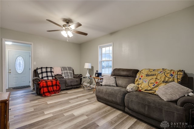 living room featuring ceiling fan and light hardwood / wood-style floors