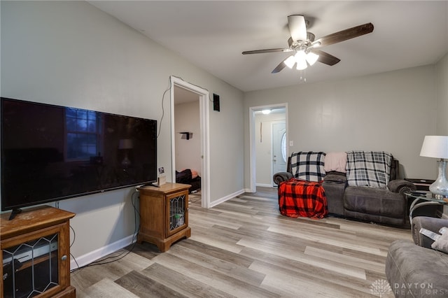 living room featuring ceiling fan and light hardwood / wood-style floors