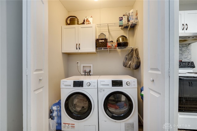 laundry area featuring washer and dryer and cabinets