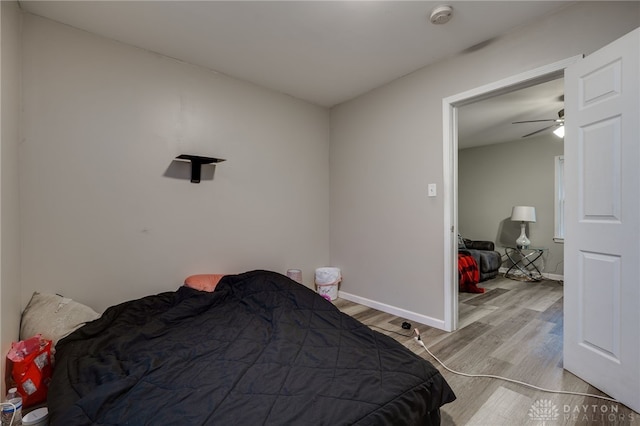 bedroom with light wood-type flooring and vaulted ceiling